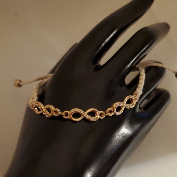 Gold and White Infinity Bracelet with Intricate Design - Picture 3 of 8